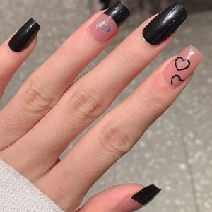 Glossy black and pink press-on nails with silver glitter and heart patterns in long square shape