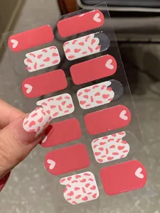 Detail of pink heart and cow print nail polish wraps with glossy finish and 14 stickers