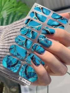 Detail of blue marble nail stickers with gold foil texture and agate pattern finish