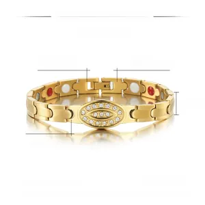 Macro detail of gold-plated stainless steel magnetic therapy bracelet with inset crystals