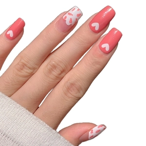 Pink heart pattern nail stickers with white spotted design for a sweet manicure look