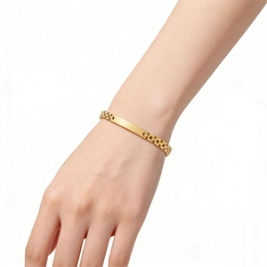 Detail of 6mm gold stainless steel watchband link bracelet worn on a female wrist