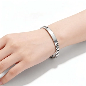 Close-up of a 6mm stainless steel ID bracelet with a polished metal plate on wrist