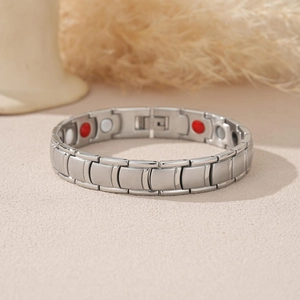 Men's stainless steel magnetic bracelet with silver matte finish on a soft pink base