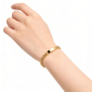 Detail of 18K gold-plated stainless steel watch-style bracelet with polished bar