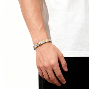 Detail of men's two-tone dragon scale bracelet in gold and silver on male wrist