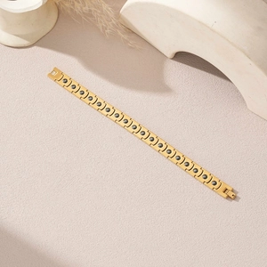 Détail macro du bracelet en acier doré avec aimants intégrés et fermoir pliable