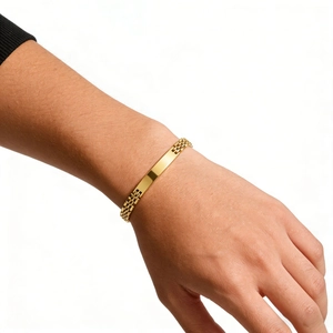 Detail of 6mm 18K gold plated stainless steel watch-style ID bracelet on wrist