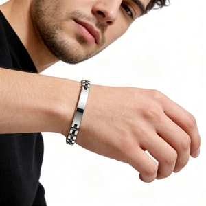 Macro detail of 6mm stainless steel ID bracelet with polished watchband style links on wrist
