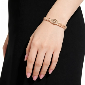Close-up of rose gold stainless steel magnetic bracelet with evil eye diamond charm