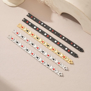 Close-up of stainless steel magnetic therapy bracelets with colored functional inserts