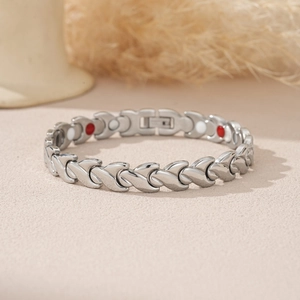 Detail view of silver magnetic therapy bracelet with polished links and dual-tone stones