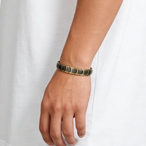 Close-up of men's gold and black stainless steel bracelet with magnetic link design