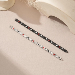 Detail of magnetic stainless steel bracelets with colorful health beads and matte finish