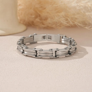Detail of industrial multi-layer stainless steel bracelet with rivet accents and clasp