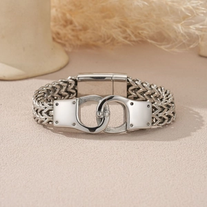 Detail of silver stainless steel wide chain bracelet with unique handcuff buckle design