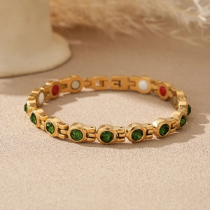 Détail d'un bracelet magnétique doré avec pierres colorées et disques fonctionnels