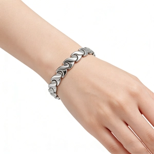 Polished silver fishtail stainless steel magnetic bracelet worn on a wrist for health