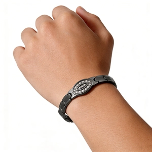 Close-up of black stainless steel bracelet featuring a crystal-encrusted oval centerpiece
