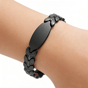 Detailed close-up of matte black wheat link magnetic bracelet with flat bar plate