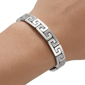 Detailed view of silver stainless steel chain bracelet with Greek key meander pattern