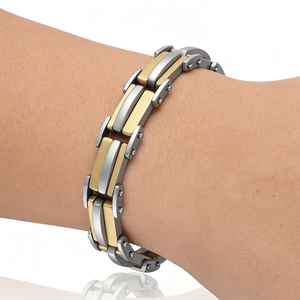 Gros plan d'un bracelet industriel pour homme en acier inoxydable argenté et doré