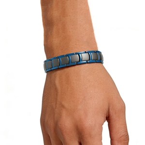 Detailed shot of men's steel link bracelet with grey and blue magnetic nail patterns