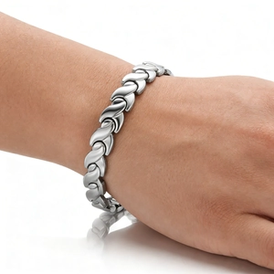 Macro side view of polished stainless steel fish tail link bracelet worn on a wrist
