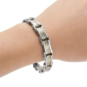 Detail of silver and gold link bracelet with industrial screw accents on wrist