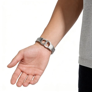 Polished silver stainless steel NK handcuff bracelet for men on wrist with metal chain