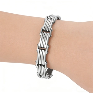 Macro detail of layered stainless steel bracelet with industrial mechanical link structure