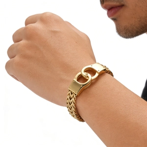 Macro view of gold stainless steel men's handcuff link bracelet with double row chain