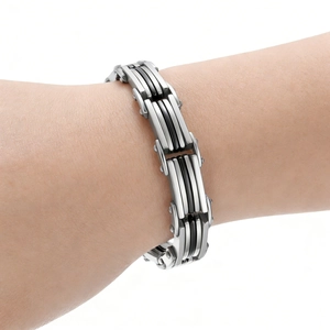 Close-up of industrial style men's bracelet with silver steel and black accents
