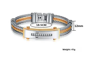 Detail of cable wire men's bracelet with silver and gold finish and CZ stone cross