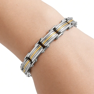 Detail of men's layered stainless steel bracelet with silver and gold industrial links