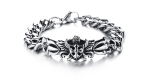 Detail of silver steel Cuban link bracelet featuring a gothic shield and cross charm