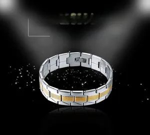 Detail of two-tone stainless steel men's bracelet with gold accents and grid pattern