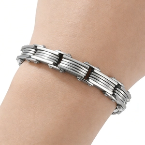 Detailed close-up of men's tiered industrial steel bracelet with side screw accents