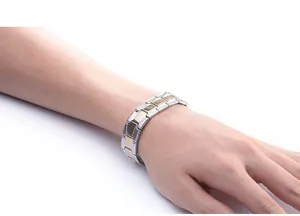 Detail of adjustable men's stainless steel watchband bracelet in gold and silver