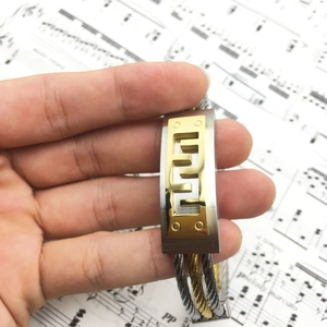 Men's two-tone stainless steel cable bracelet with geometric hollowed metal plate
