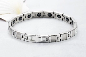 Detailed macro view of silver titanium magnetic health bracelet with polished links