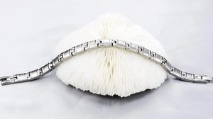 Detailed shot of silver titanium steel link bracelet featuring a polished mirror finish