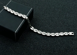 Detail of silver magnetic therapy bracelet with metallic links and dark magnetic beads