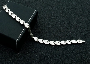 Macro shot of silver magnetic titanium steel bracelet on black leather display case