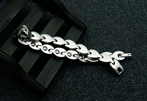 Macro detail of silver magnetic therapy bracelet with teardrop links and stone inserts