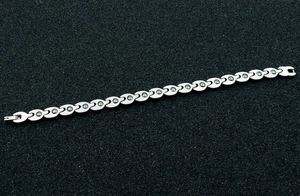 Detail of silver magnetic therapy bracelet with round stones on black background