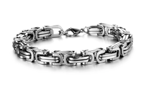 Macro shot of polished silver Byzantine chain link bracelet with lobster clasp