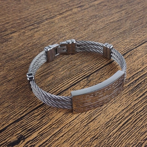 Detailed view of stainless steel twisted wire bracelet with Greek key pattern buckle