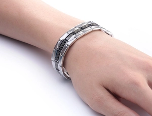 Men's stainless steel bracelet featuring Greek key pattern and black enamel links