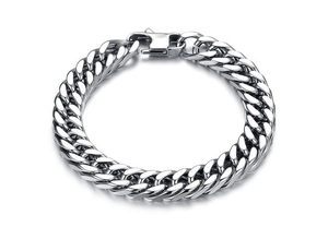 Detailed close-up of a bold silver stainless steel curb chain bracelet with lobster clasp